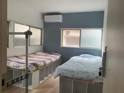 a bedroom with two bunk beds and two windows at Tokyo Skytree Tower - Asakusa Auberge de Jeunesse in Tokyo
