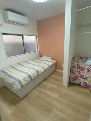 a small bedroom with a bed and a window at Tokyo Skytree Tower - Asakusa Auberge de Jeunesse in Tokyo