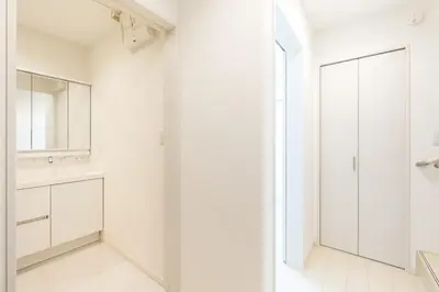 a white bathroom with a sink and a mirror at Near Shinjuku 3 stops in Tokyo