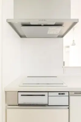 a white kitchen with a stove top oven at Near Shinjuku 3 stops in Tokyo