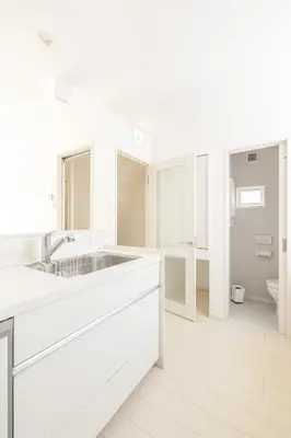a white kitchen with a sink and a toilet at Near Shinjuku 3 stops in Tokyo
