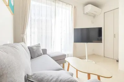a living room with a couch and a tv at Near Shinjuku 3 stops in Tokyo