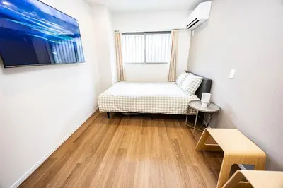 a small room with a bed and a window at Hiro Yanaka hotel TT0421 in Tokyo