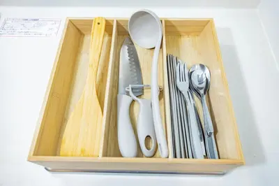 a wooden drawer with utensils in it at Hiro Yanaka hotel TT0421 in Tokyo