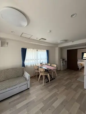 a living room with a couch and a table at \u671d\u65e5\u8857\u306e\u5bbf An inn on Asahi Street in Tokyo