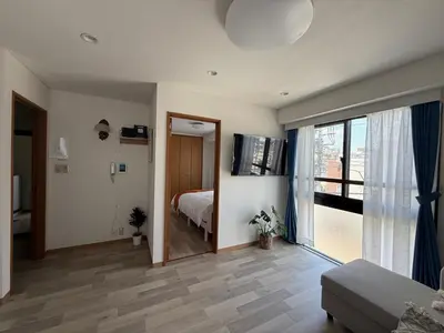 a bedroom with a bed and a large window at \u671d\u65e5\u8857\u306e\u5bbf An inn on Asahi Street in Tokyo