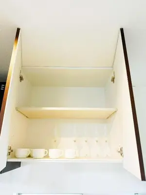 a shelf in a kitchen with white cups on it at \u6587\u4eachouse 202 in Tokyo