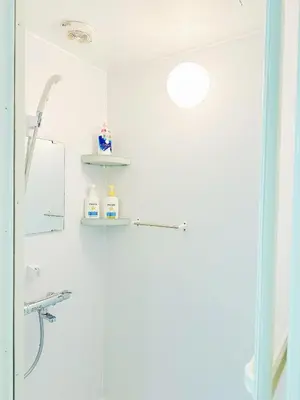 a bathroom with a shower with a glass door at \u6587\u4eachouse 202 in Tokyo