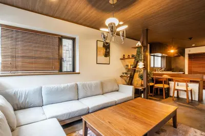 a living room with a couch and a table at 8 min walk to station 11 min to HND airport 85 sqm max 8 people full renovation 2 toilets Netflix in Tokyo