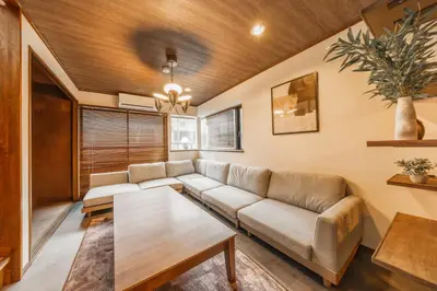 a living room with a couch and a table at 8 min walk to station 11 min to HND airport 85 sqm max 8 people full renovation 2 toilets Netflix in Tokyo