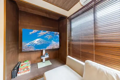 a room with a large window with a tv on the wall at 8 min walk to station 11 min to HND airport 85 sqm max 8 people full renovation 2 toilets Netflix in Tokyo