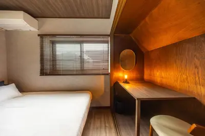 a bedroom with a bed and a desk with a mirror at 8 min walk to station 11 min to HND airport 85 sqm max 8 people full renovation 2 toilets Netflix in Tokyo