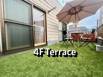 a patio with an umbrella and a table and chairs at \u767d\u5c71\u30ed\u30a4\u30e4\u30eb\u30cf\u30a6\u30b9 in Tokyo