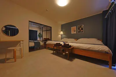 a bedroom with a bed and a desk and a desk at Oneness House Tokyo \u6771\u4eac\u56db\u30c4\u6728 in Tokyo