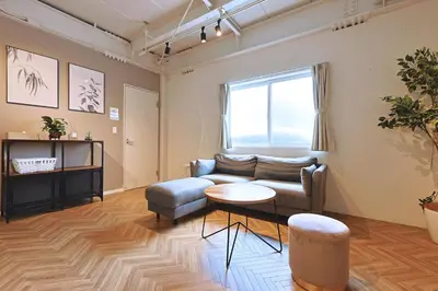 a living room with a couch and a table at Oneness House Tokyo \u6771\u4eac\u56db\u30c4\u6728 in Tokyo