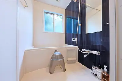 a bathroom with a shower with a trash can at Oneness House Tokyo \u6771\u4eac\u56db\u30c4\u6728 in Tokyo