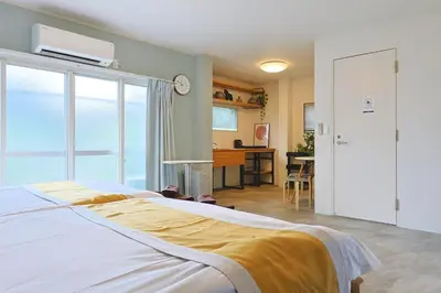 a bedroom with a bed and a room with a desk at Oneness House Tokyo \u6771\u4eac\u56db\u30c4\u6728 in Tokyo
