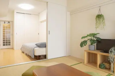 a living room with a bed and a mirror at Kabukicho 507-SJ0011 in Tokyo