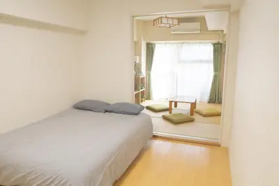 a bedroom with a bed and a window and a table at Kabukicho 507-SJ0011 in Tokyo