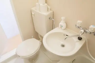 a white bathroom with a toilet and a sink at Kabukicho 507-SJ0011 in Tokyo
