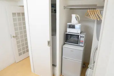 a kitchen with a microwave on top of a refrigerator at Kabukicho 507-SJ0011 in Tokyo