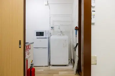 a kitchen with two refrigerators and a microwave at M-Stay Nishishinjuku II, Room 202 in Tokyo