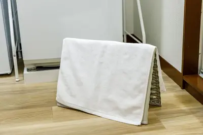 a towel is draped over the back of a room at M-Stay Nishishinjuku II, Room 202 in Tokyo