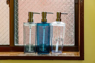 three bottles of water sitting on a window sill at M-Stay Nishishinjuku II, Room 202 in Tokyo