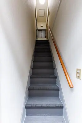 a staircase in a building with a stair case at M-Stay Nishishinjuku II, Room 202 in Tokyo