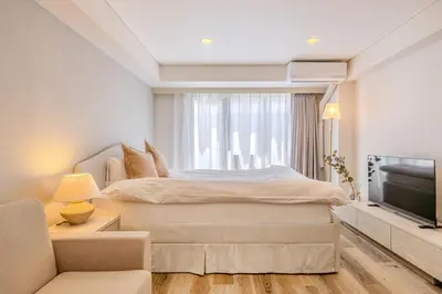 a bedroom with a bed and a flat screen tv at Feel Stay\u9053\u7384\u5742506 in Tokyo