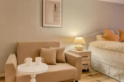 a living room with a couch and a table and a bed at Feel Stay\u9053\u7384\u5742506 in Tokyo