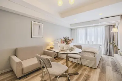 a living room with a couch and a table and chairs at Feel Stay\u9053\u7384\u5742506 in Tokyo
