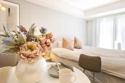 a living room with a vase with flowers on a table at Feel Stay\u9053\u7384\u5742506 in Tokyo