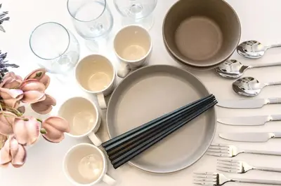 a table with plates and glasses and utensils at Feel Stay\u9053\u7384\u5742506 in Tokyo