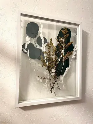 a framed picture of flowers and leaves on a wall at n'imo HOUSE 101 in Tokyo
