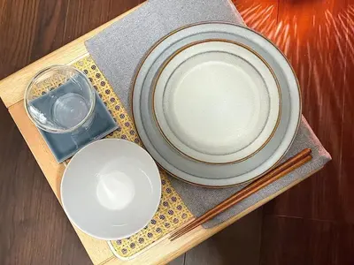 a table with plates and chopsticks on a wooden tray at n'imo HOUSE 101 in Tokyo