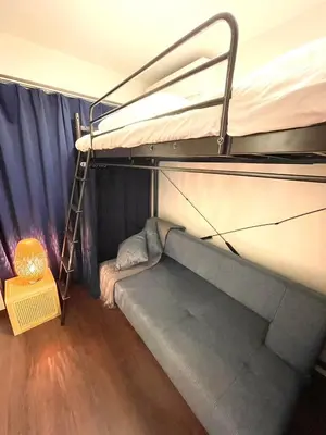 a room with a bunk bed and a ladder at n'imo HOUSE 101 in Tokyo