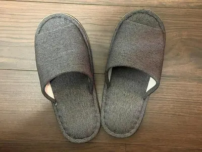a pair of gray shoes on a wooden floor at n'imo HOUSE 101 in Tokyo