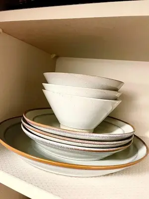 a stack of plates sitting on a shelf at n'imo HOUSE 101 in Tokyo