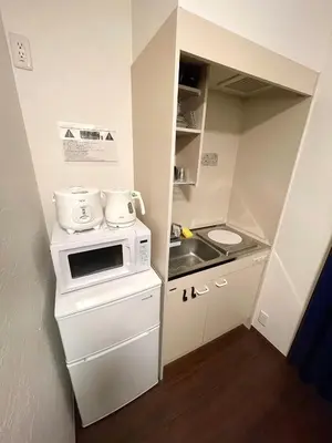 a small kitchen with a stove and a sink at n'imo HOUSE 101 in Tokyo