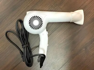 a hair dryer sitting on top of a wooden floor at n'imo HOUSE 101 in Tokyo