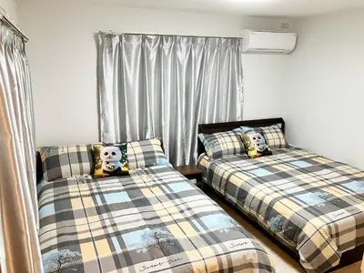 two beds with panda pillows in a bedroom at Uenoyuyunoie - Vacation STAY 19367 in Tokyo