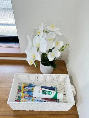 a table with a vase with flowers and a tube of toothpaste at GreatViewHouse - Vacation STAY 19425 in Tokyo