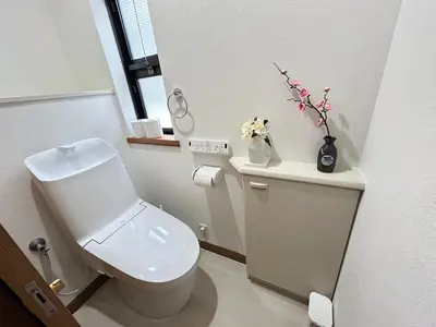 a white bathroom with a toilet and a vase of flowers at GreatViewHouse - Vacation STAY 19425 in Tokyo