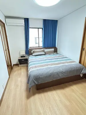 a bedroom with a large bed with blue curtains at GreatViewHouse - Vacation STAY 19425 in Tokyo