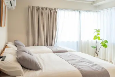 two beds with pillows in a bedroom with a window at Improve Nishi Magome - Vacation STAY 19541 in Tokyo