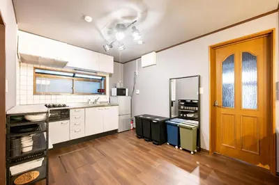 a kitchen with white cabinets and a wooden door at Nakaitabashi Kotate - Vacation STAY 19730 in Tokyo