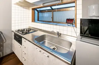 a kitchen with a stainless steel sink and a window at Nakaitabashi Kotate - Vacation STAY 19730 in Tokyo