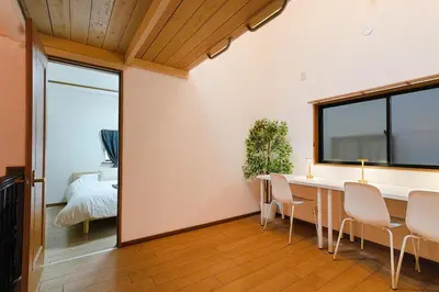 a dining room with a table and chairs and a bed at \u30e1\u30fc\u30a4\u30f3\u65b0\u5bbf in Tokyo