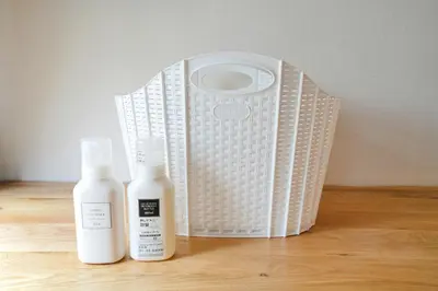two bottles of lotion sitting next to a white basket at \u30e1\u30fc\u30a4\u30f3\u65b0\u5bbf in Tokyo
